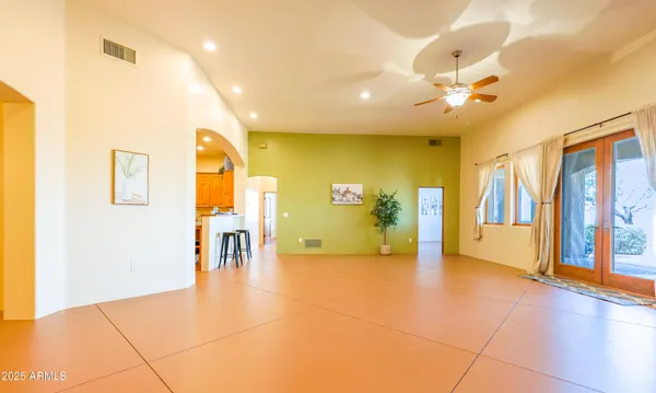 a kitchen with stainless steel appliances granite countertop a sink a stove cabinets and a dining table