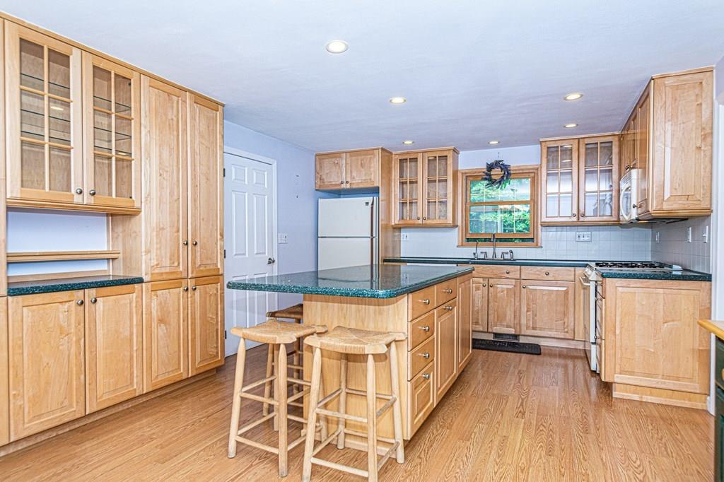 487 Boston Road Groton, MA 01450 - Photo 3 of 32 a kitchen with a sink window and cabinets
