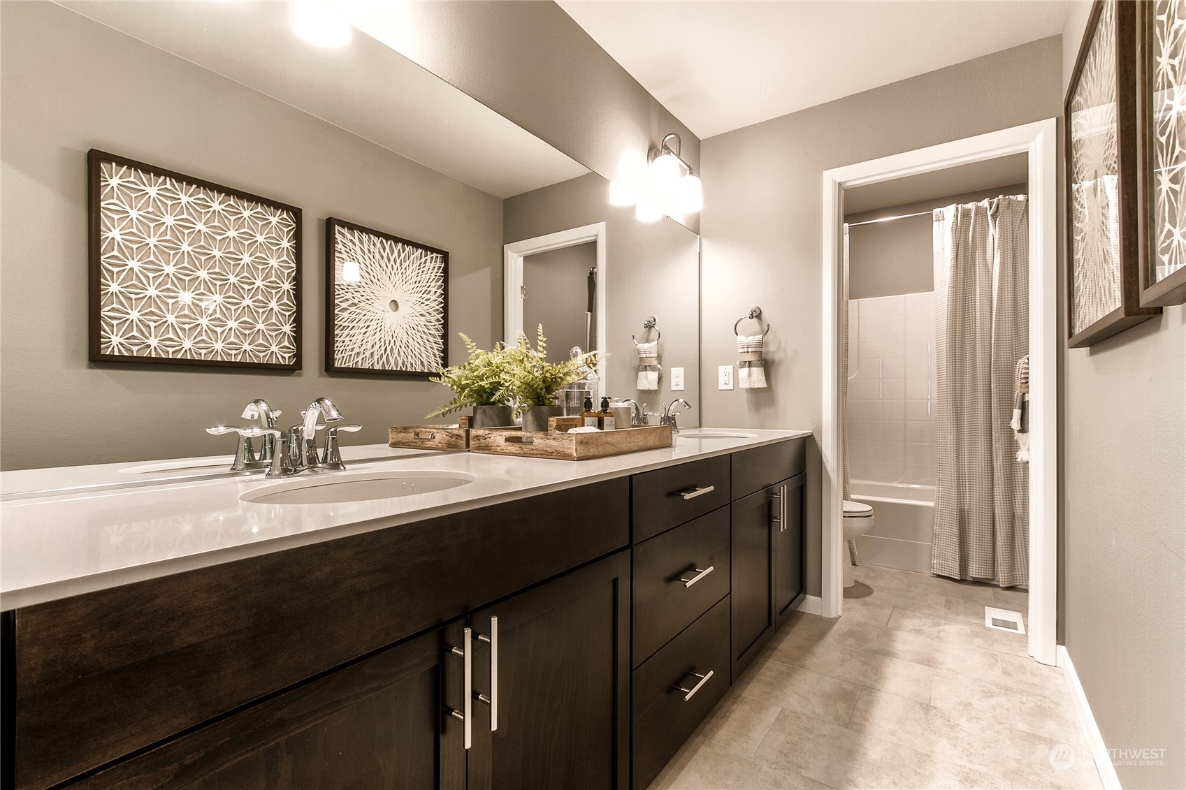 21116 42nd Drive Southeast, Unit 125 Bothell, WA 98021 - Photo 12 of 16 a bathroom with a sink a toilet and a mirror