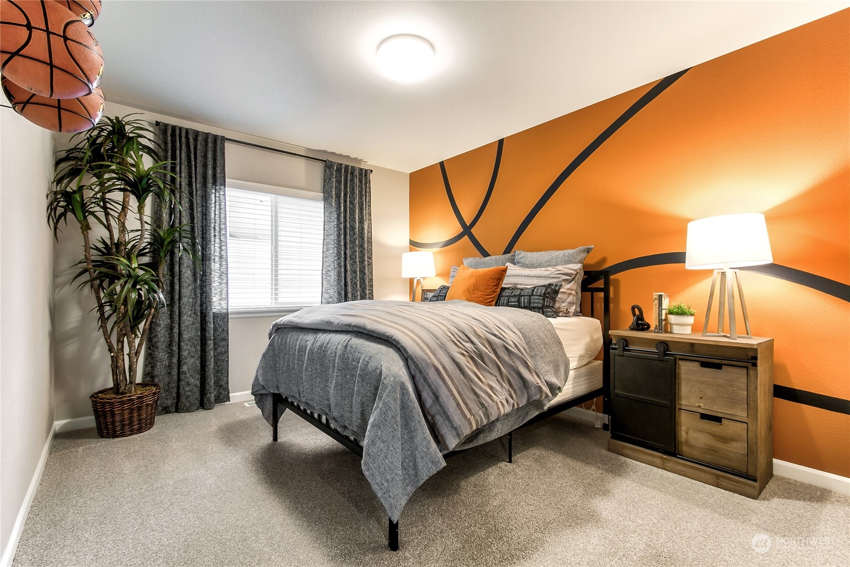 21116 42nd Drive Southeast, Unit 125 Bothell, WA 98021 - Photo 13 of 16 a bedroom with a bed and a potted plant next to a window