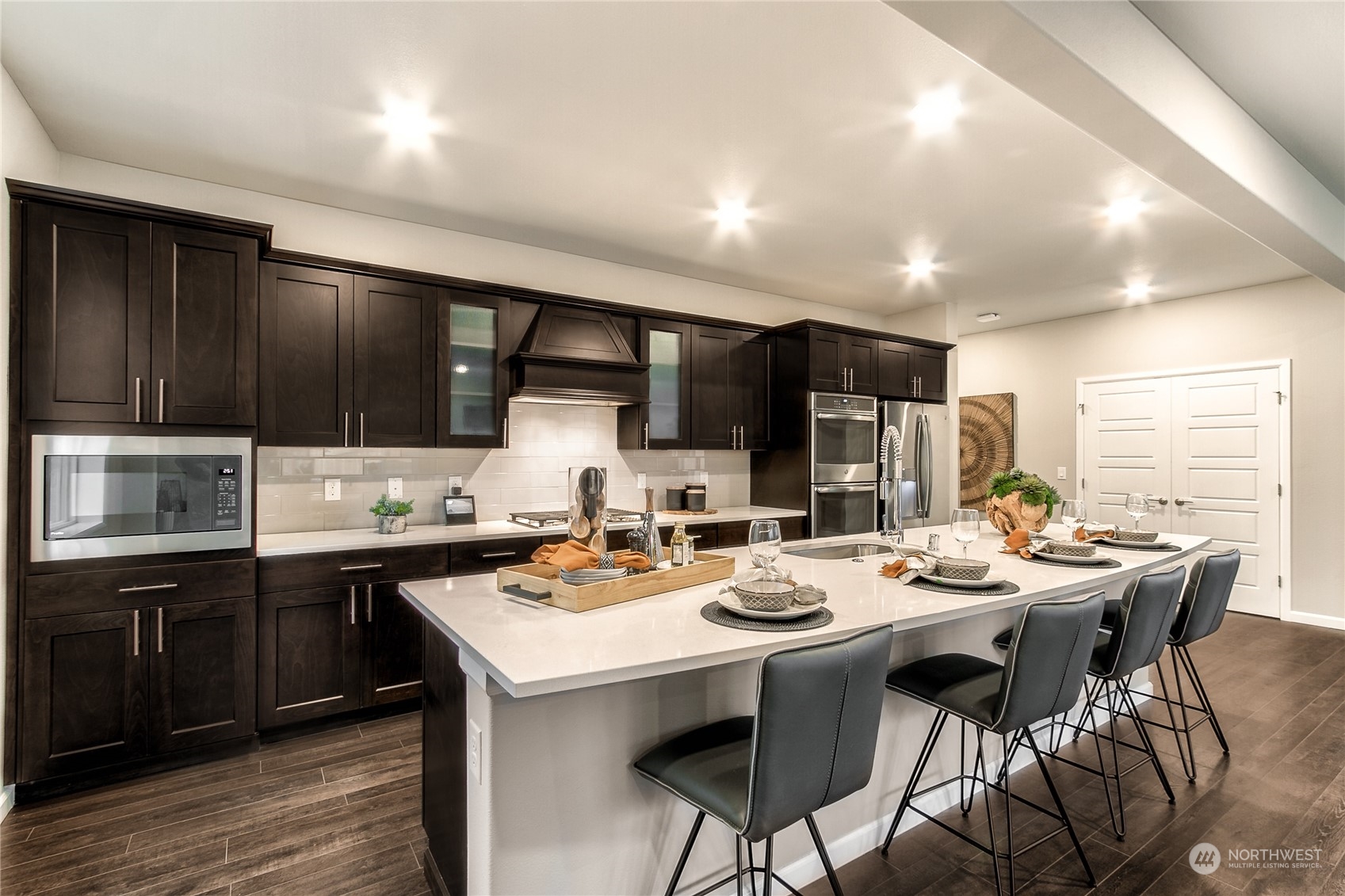 21116 42nd Drive Southeast, Unit 125 Bothell, WA 98021 - Photo 3 of 16 a kitchen with lots of counter space a sink and chairs