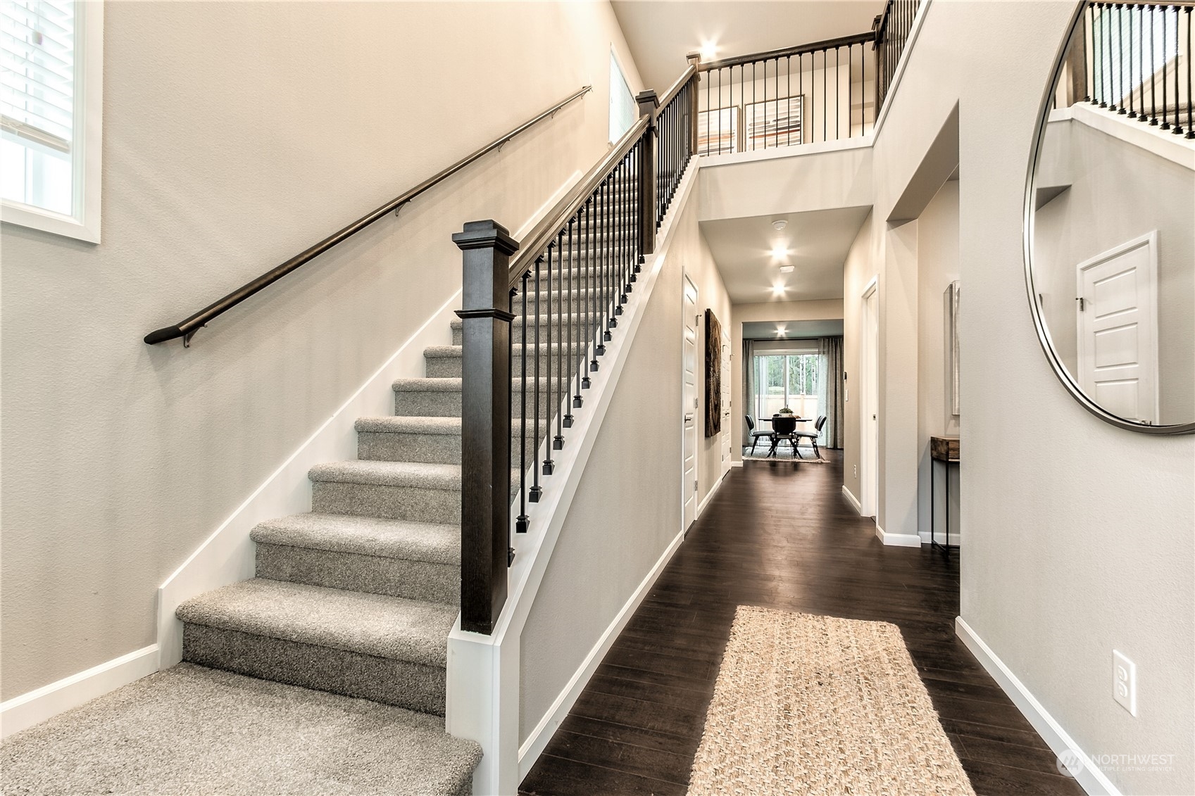 21116 42nd Drive Southeast, Unit 125 Bothell, WA 98021 - Photo 5 of 16 a view of staircase with lots of frames on wall and a rug