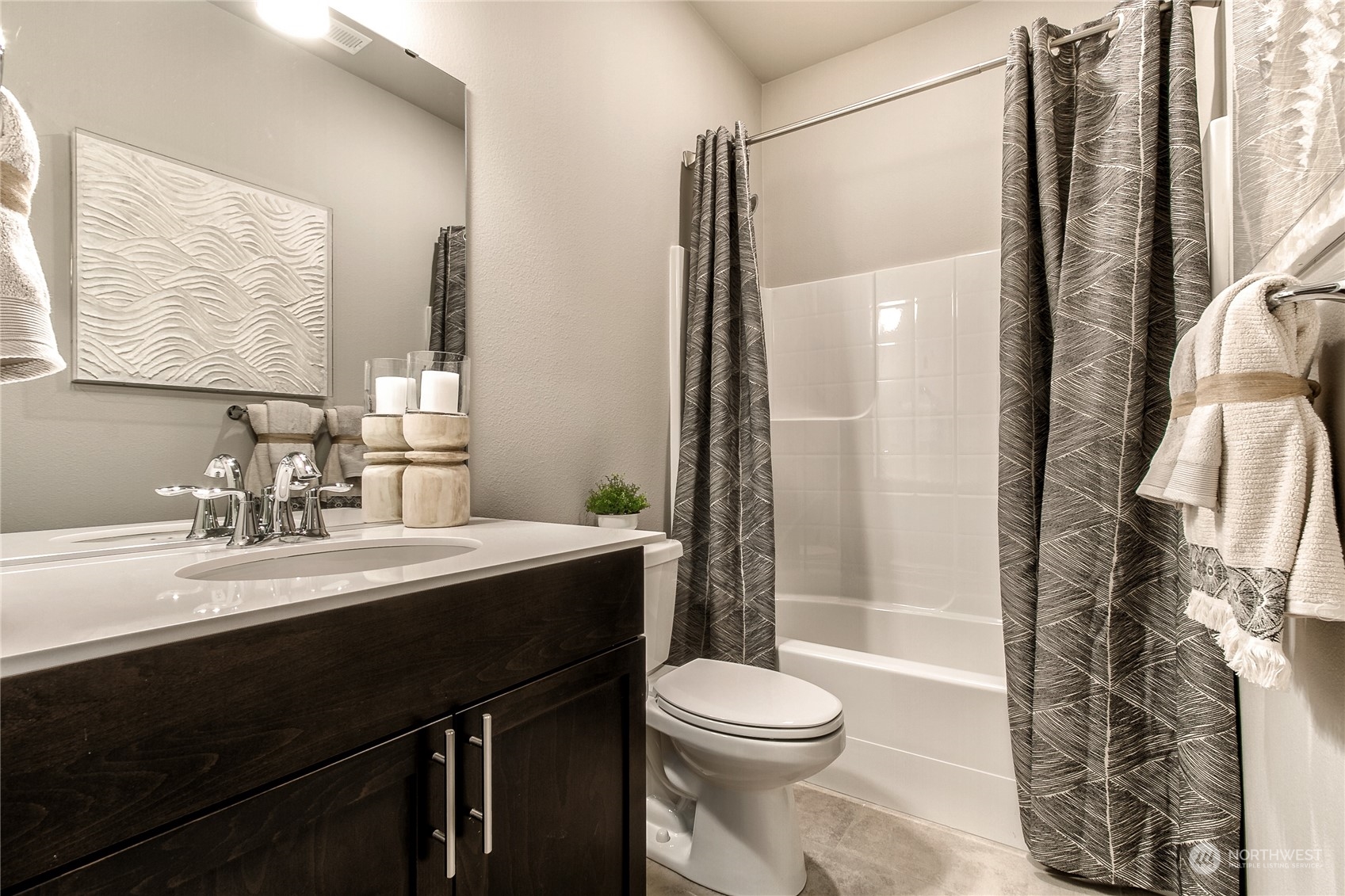 21116 42nd Drive Southeast, Unit 125 Bothell, WA 98021 - Photo 7 of 16 a bathroom with a sink a toilet a mirror and shower
