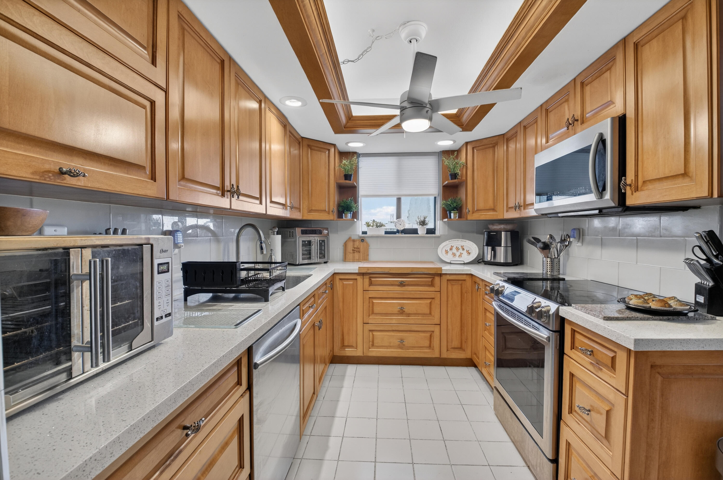 6372 La Costa Drive, Unit 705 Boca Raton, FL 33433 - Photo 11 of 60 a kitchen with stainless steel appliances granite countertop a stove sink microwave and cabinets
