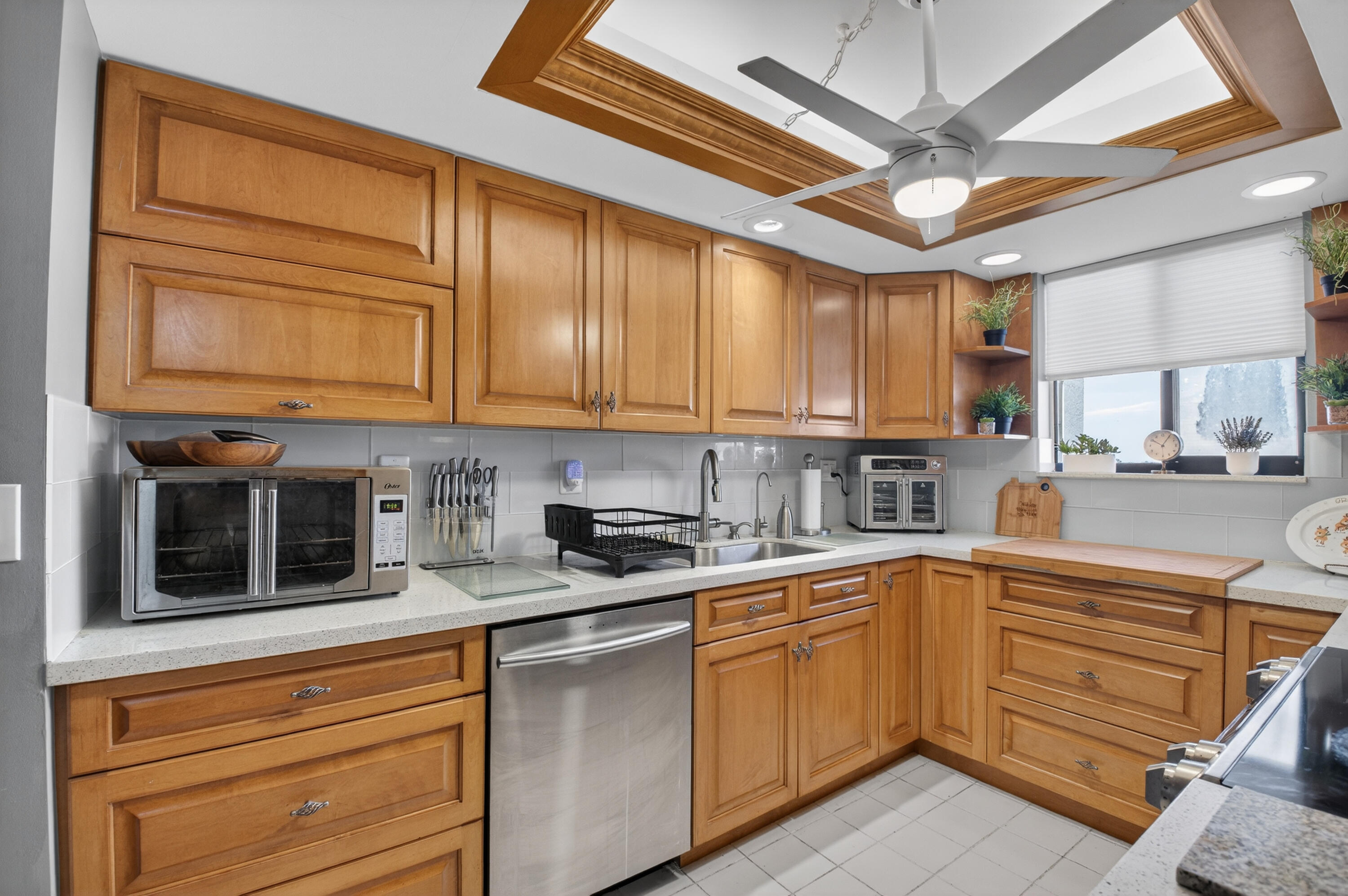 6372 La Costa Drive, Unit 705 Boca Raton, FL 33433 - Photo 12 of 60 a kitchen with stainless steel appliances granite countertop a sink a stove and cabinets