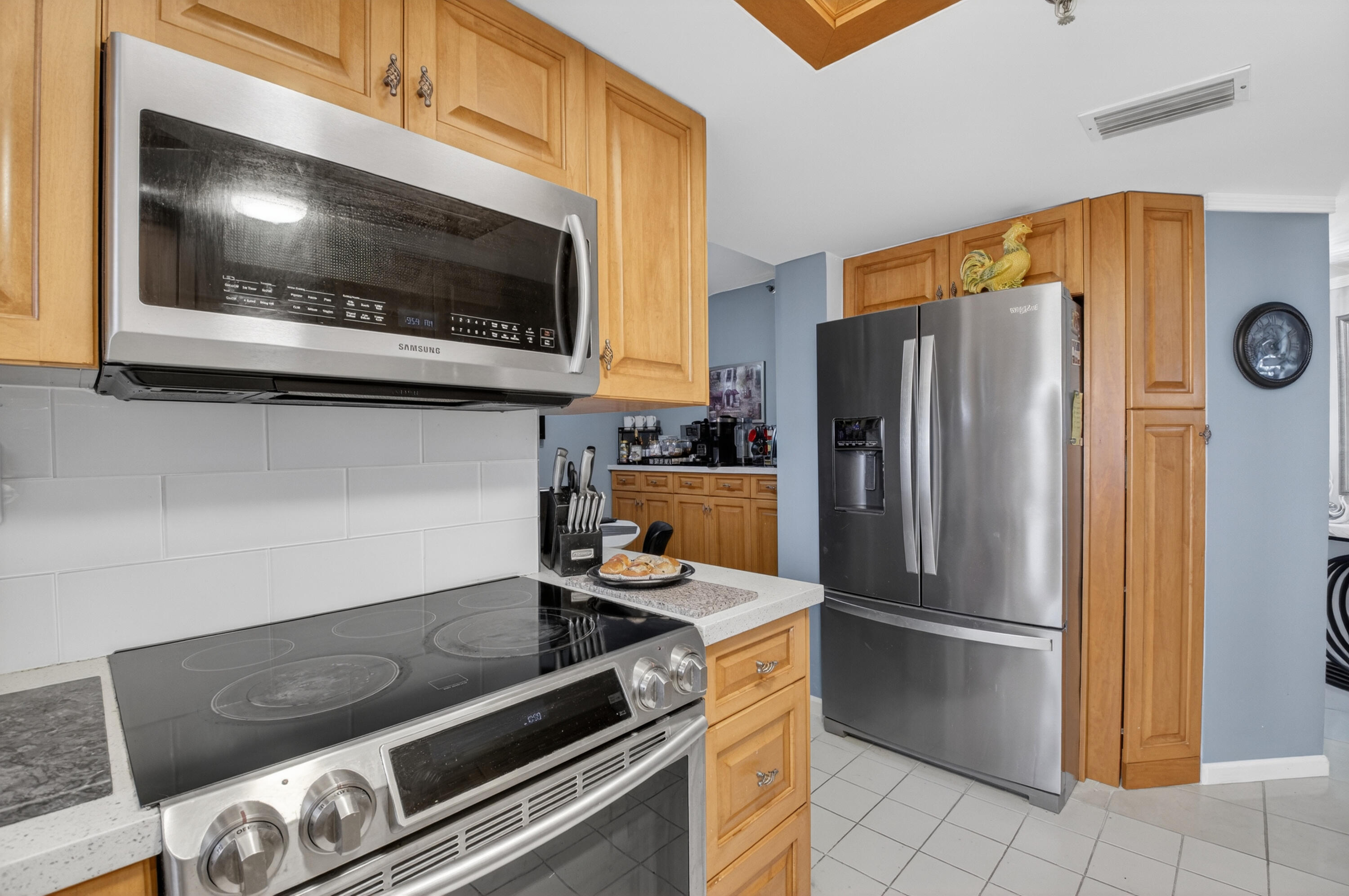 6372 La Costa Drive, Unit 705 Boca Raton, FL 33433 - Photo 14 of 60 a kitchen with a refrigerator and a stove top oven
