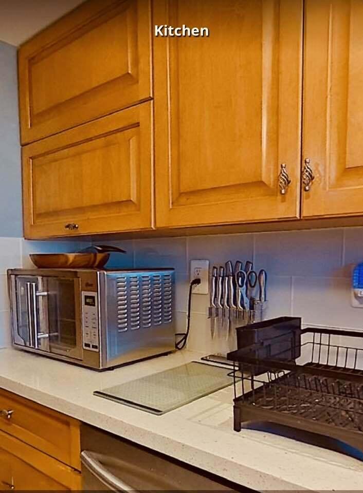 6372 La Costa Drive, Unit 705 Boca Raton, FL 33433 - Photo 18 of 60 a kitchen with a stove and a white cabinets