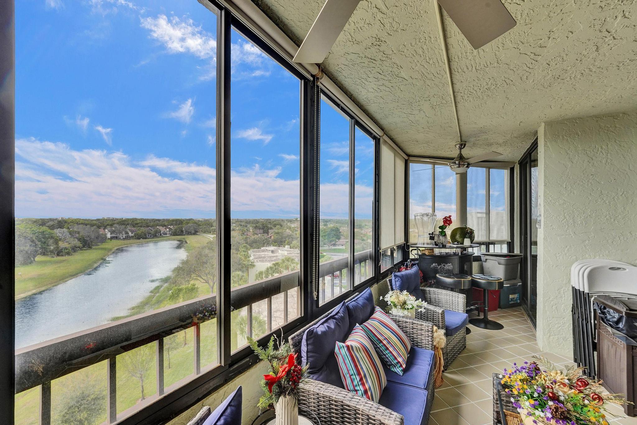 6372 La Costa Drive, Unit 705 Boca Raton, FL 33433 - Photo 23 of 60 a living room with furniture and floor to ceiling windows