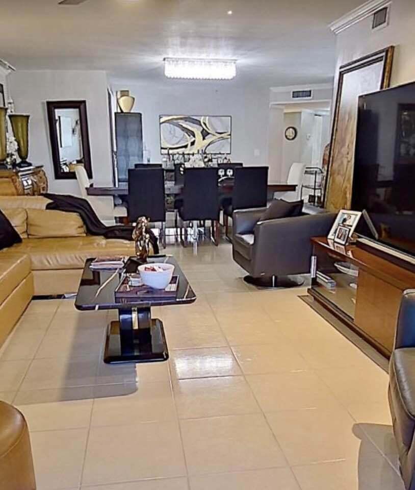 6372 La Costa Drive, Unit 705 Boca Raton, FL 33433 - Photo 25 of 60 a living room with furniture a flat screen tv and a table