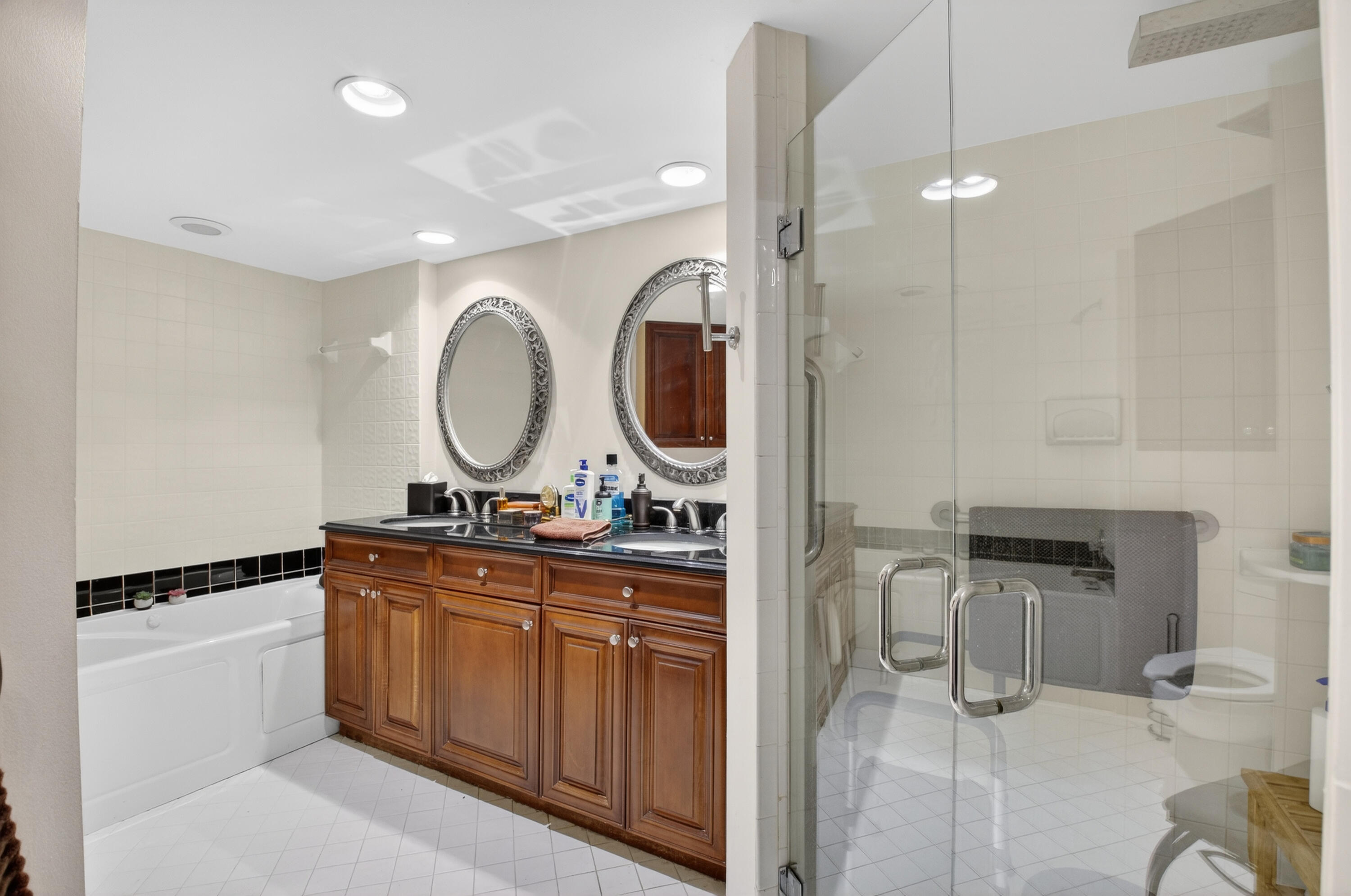 6372 La Costa Drive, Unit 705 Boca Raton, FL 33433 - Photo 35 of 60 a bathroom with a double vanity sink and a mirror