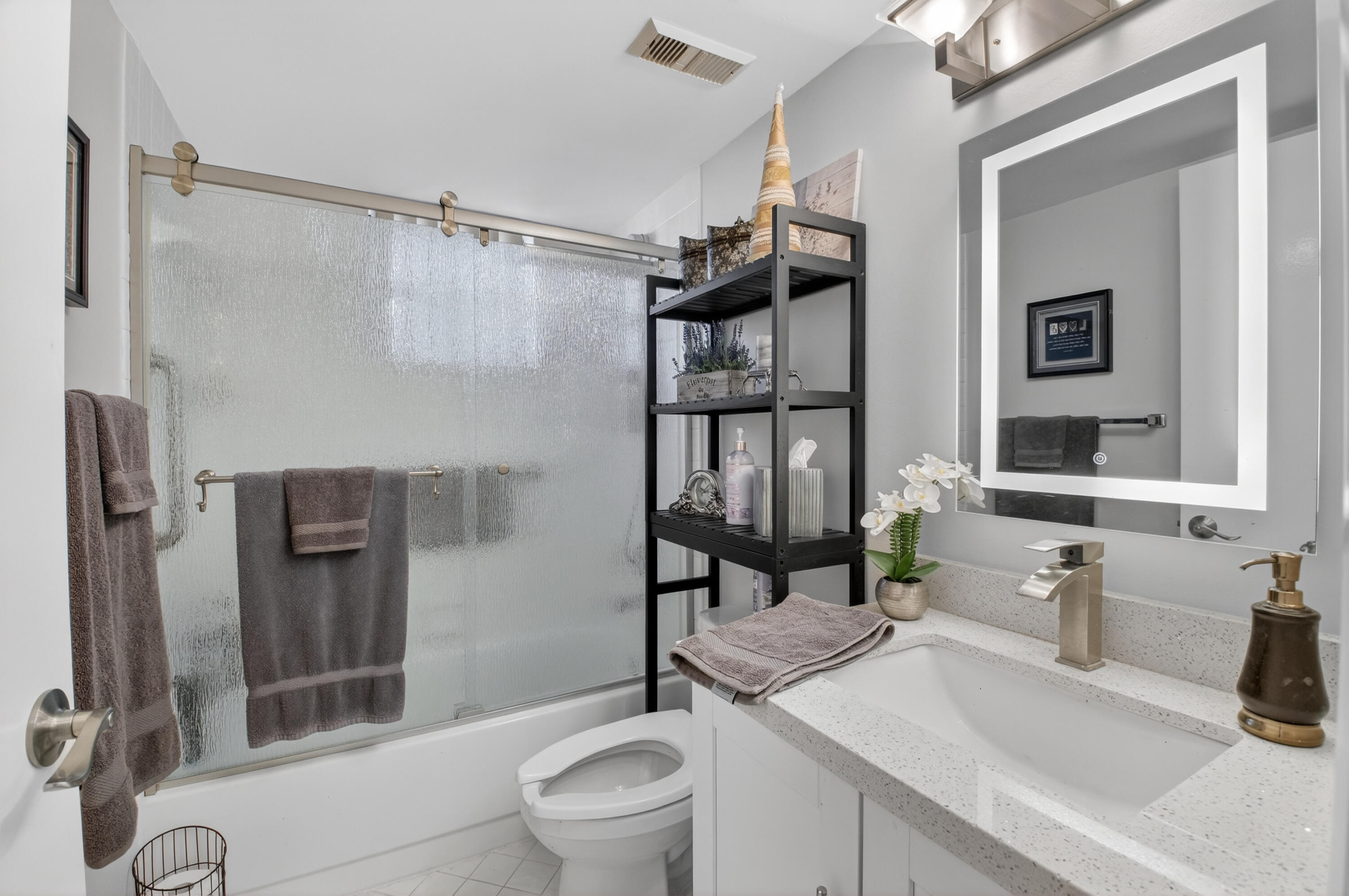 6372 La Costa Drive, Unit 705 Boca Raton, FL 33433 - Photo 37 of 60 a bathroom with a sink a toilet and shower