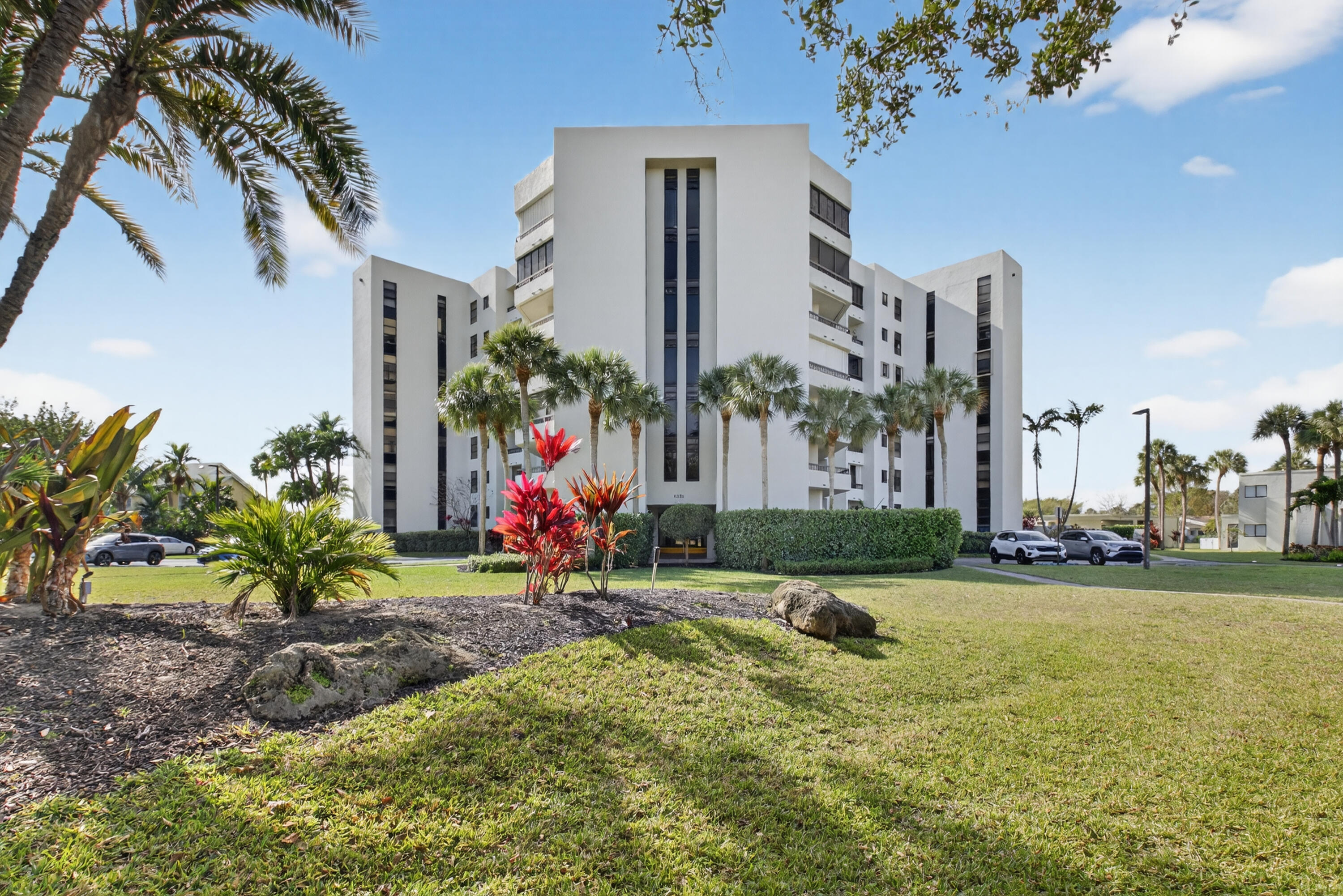 6372 La Costa Drive, Unit 705 Boca Raton, FL 33433 - Photo 51 of 60 a view of a house with a yard and a fountain