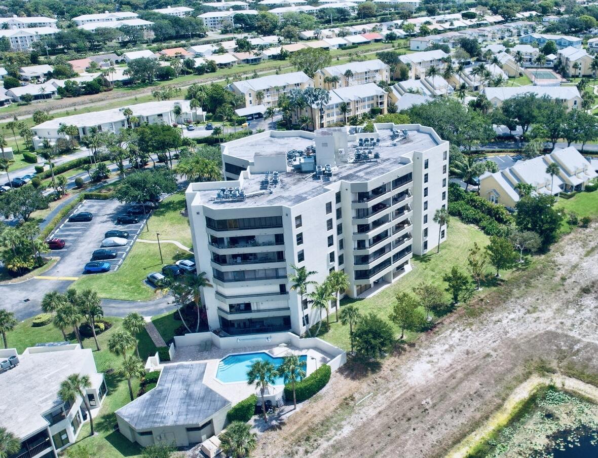 6372 La Costa Drive, Unit 705 Boca Raton, FL 33433 - Photo 57 of 60 an aerial view of a house with a yard and lake view in back