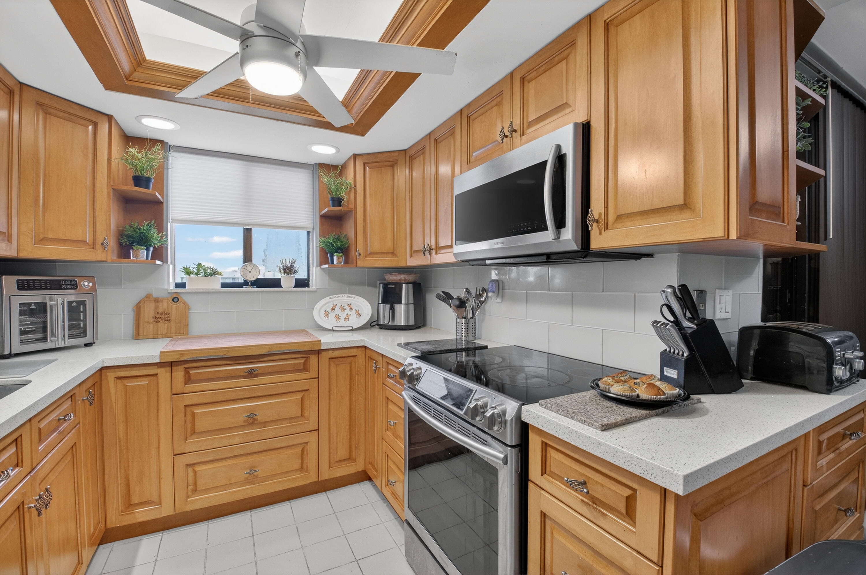 6372 La Costa Drive, Unit 705 Boca Raton, FL 33433 - Photo 9 of 60 a kitchen with stainless steel appliances granite countertop a sink stove and microwave