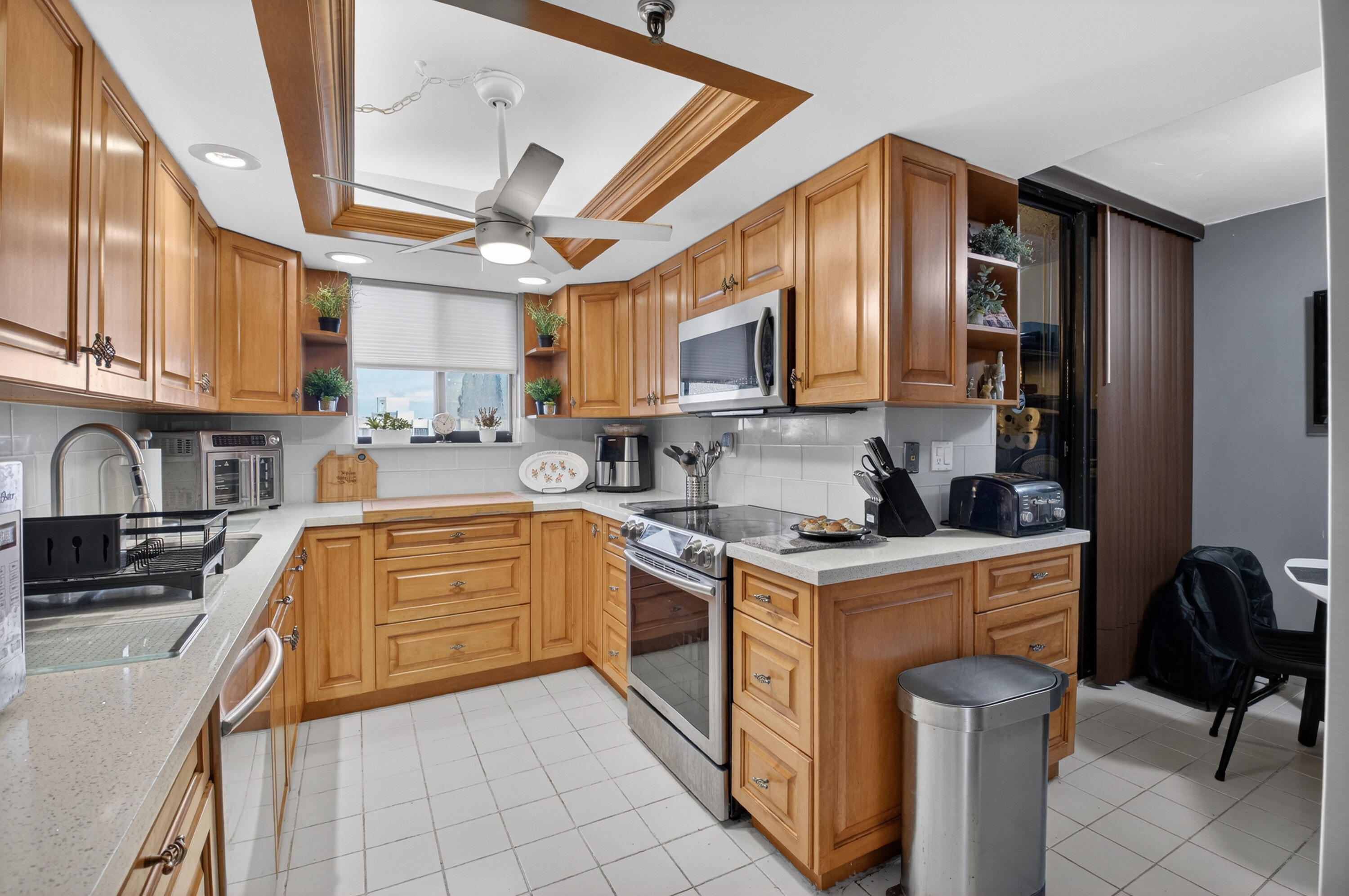 6372 La Costa Drive, Unit 705 Boca Raton, FL 33433 - Photo 10 of 60 a kitchen with stainless steel appliances granite countertop a stove sink and cabinets