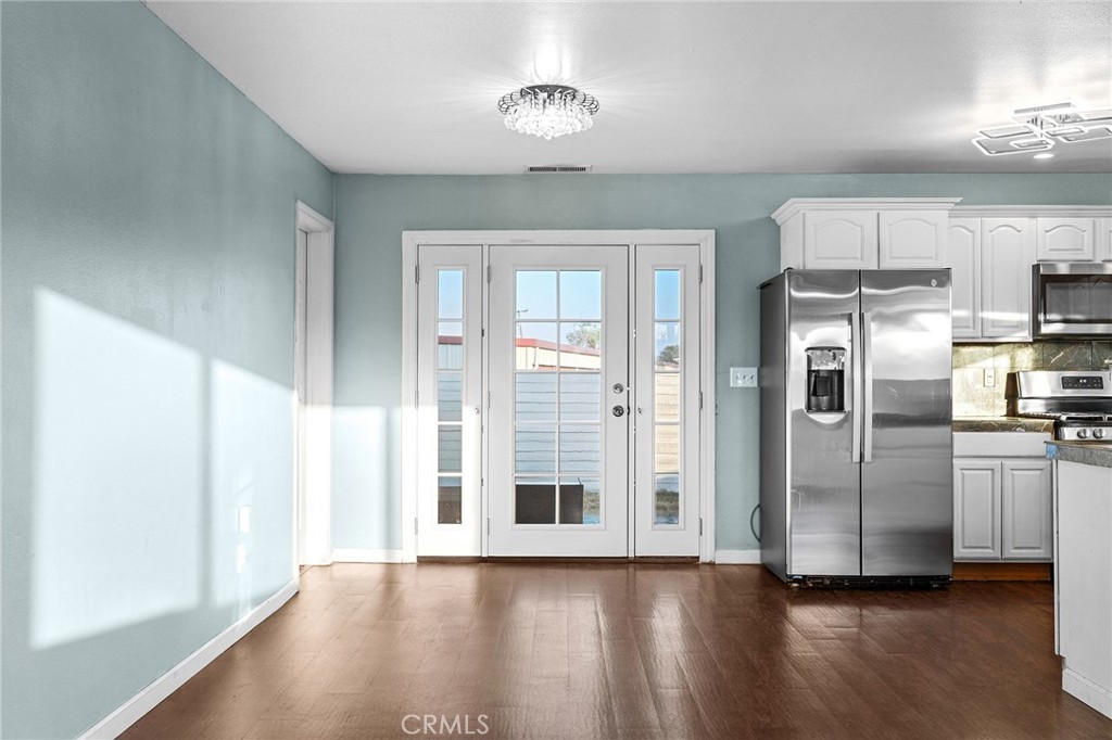 4 La Palma Drive Oroville, CA 95965 - Photo 11 of 39 a view of a kitchen with a stove fridge and wooden floor