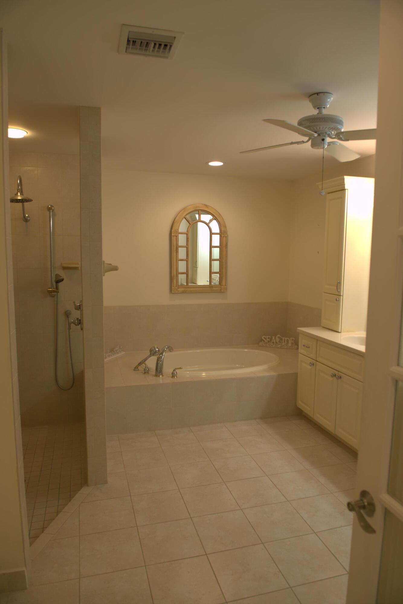 114 Beach Summit Court Jupiter, FL 33477 - Photo 20 of 32 a spacious bathroom with a bathtub and a shower