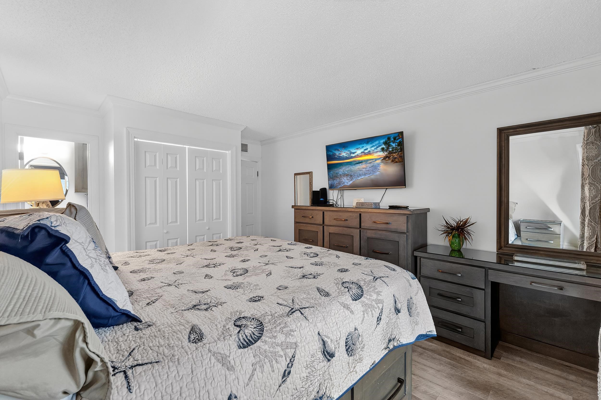 9581 Shore Drive, Unit 229 Myrtle Beach, SC 29572 - Photo 21 of 39 Bedroom featuring ornamental molding, a closet, light wood-style floors, and a textured ceiling