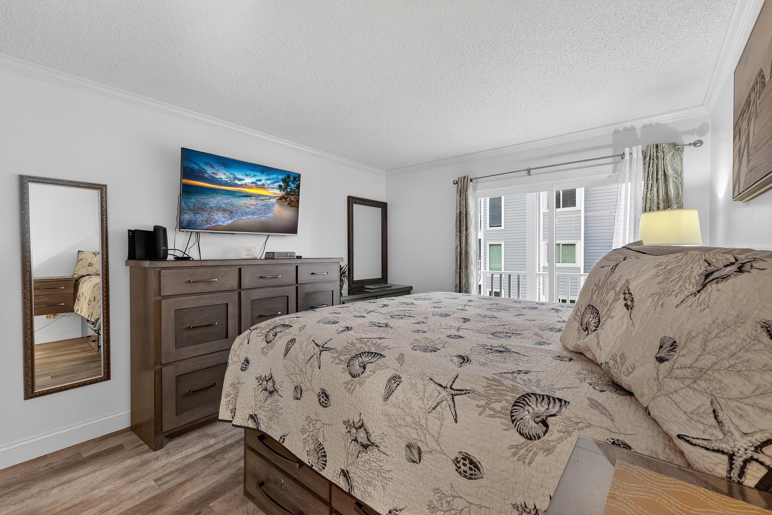 9581 Shore Drive, Unit 229 Myrtle Beach, SC 29572 - Photo 22 of 39 Bedroom featuring a textured ceiling, crown molding, light wood-type flooring, and access to outside