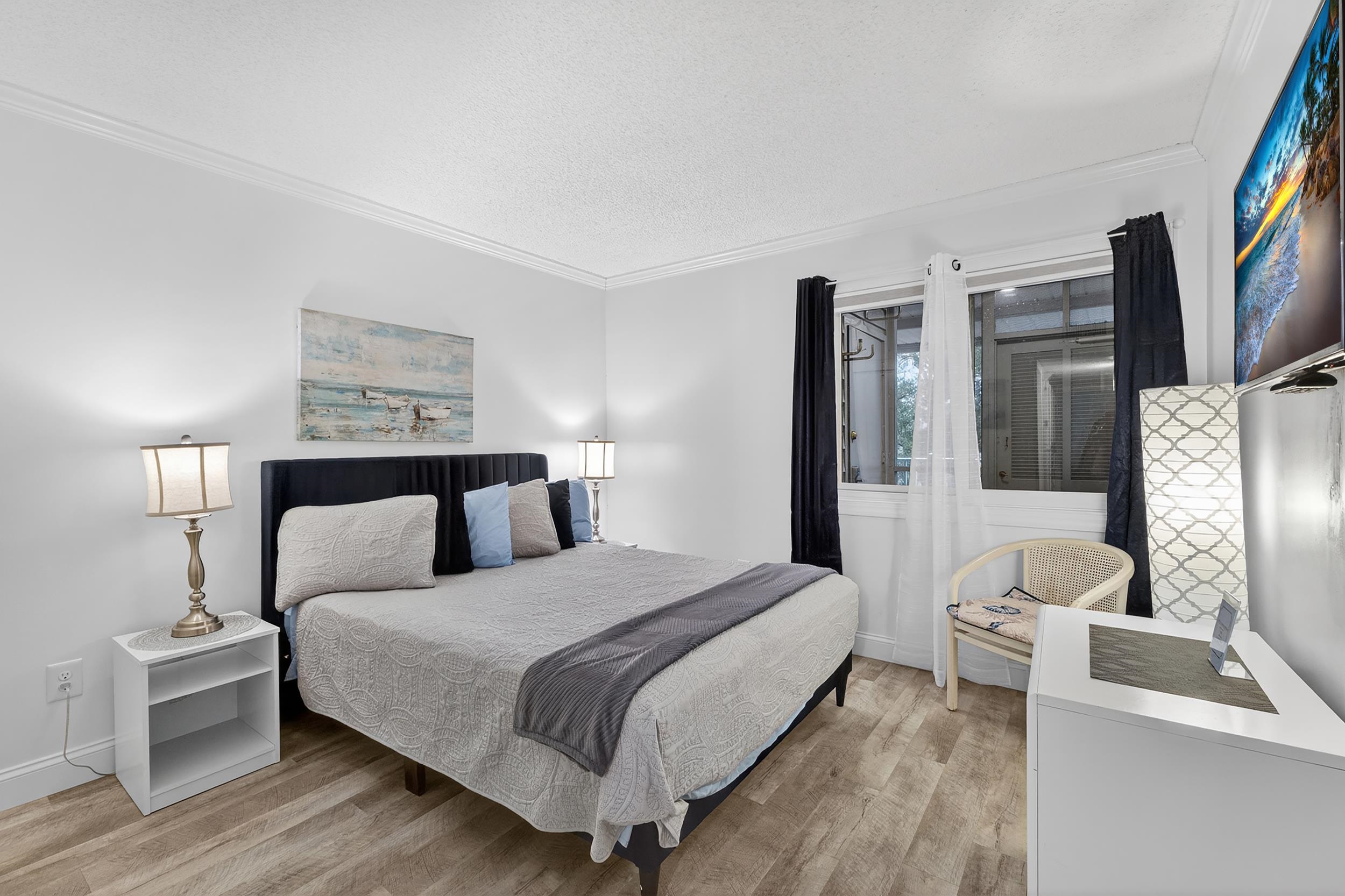 9581 Shore Drive, Unit 229 Myrtle Beach, SC 29572 - Photo 25 of 39 Bedroom featuring crown molding, light wood-type flooring, and a textured ceiling