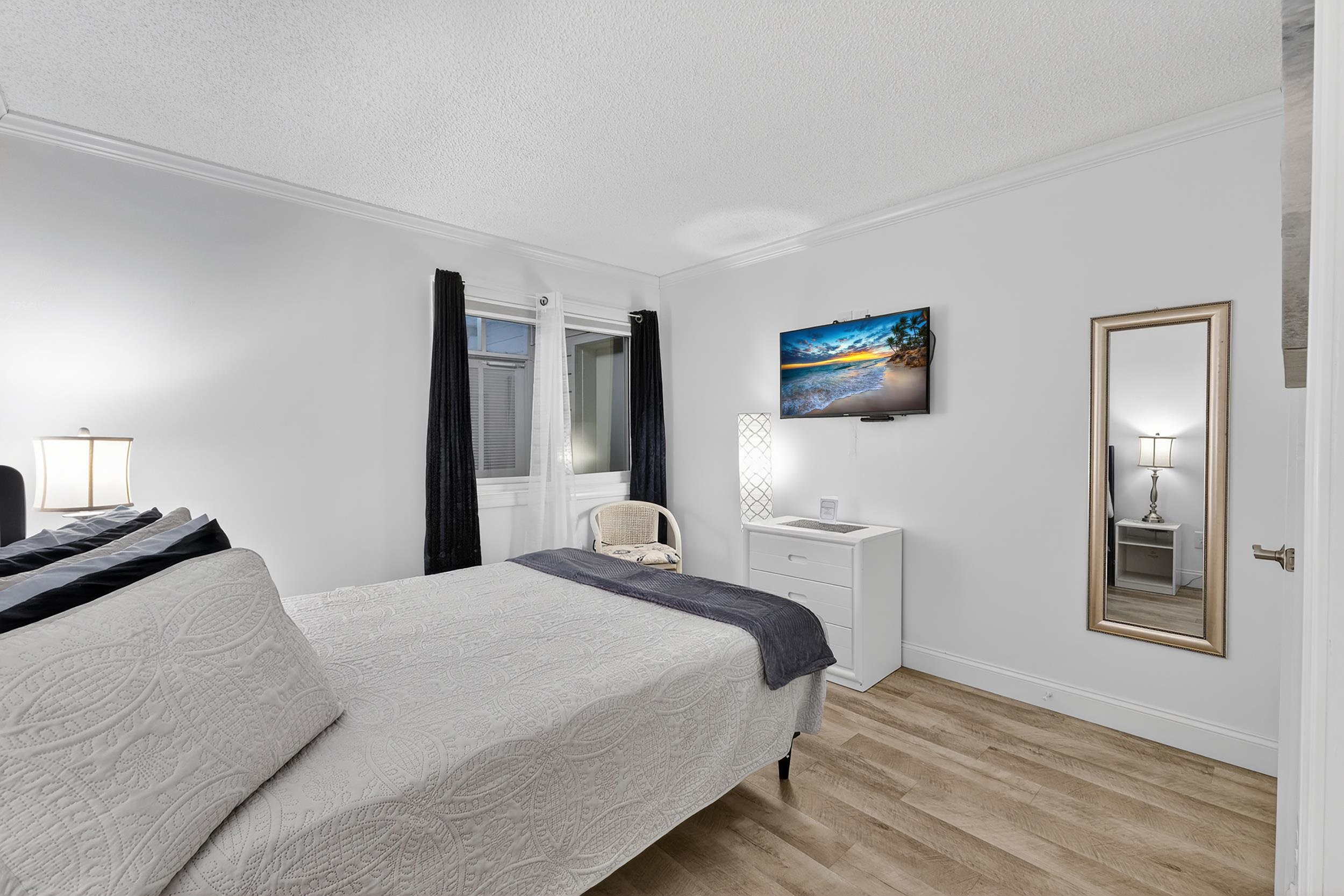 9581 Shore Drive, Unit 229 Myrtle Beach, SC 29572 - Photo 26 of 39 Bedroom with a textured ceiling, wood finished floors, and crown molding