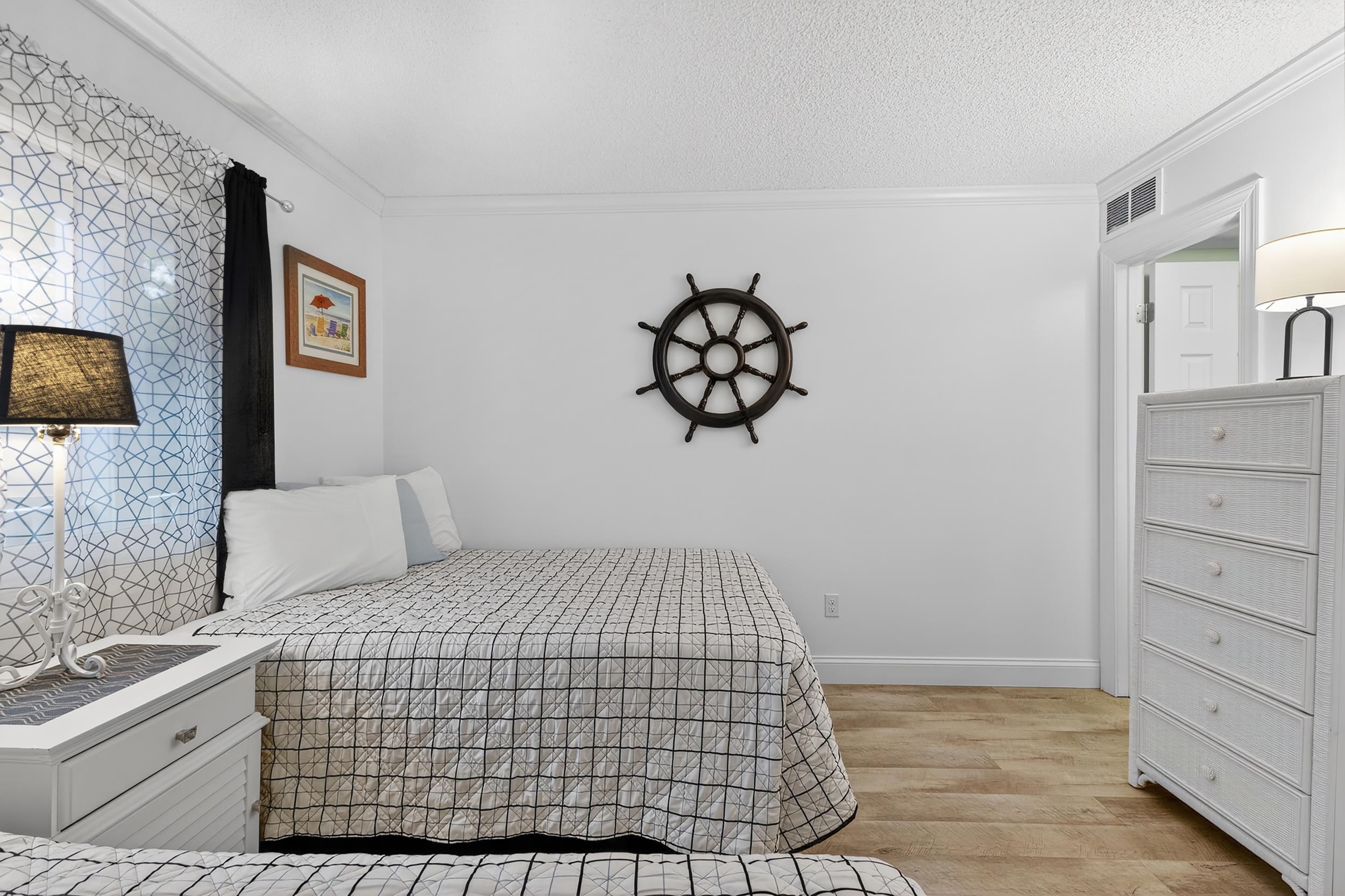 9581 Shore Drive, Unit 229 Myrtle Beach, SC 29572 - Photo 30 of 39 Bedroom with light wood-style floors, crown molding, and a textured ceiling