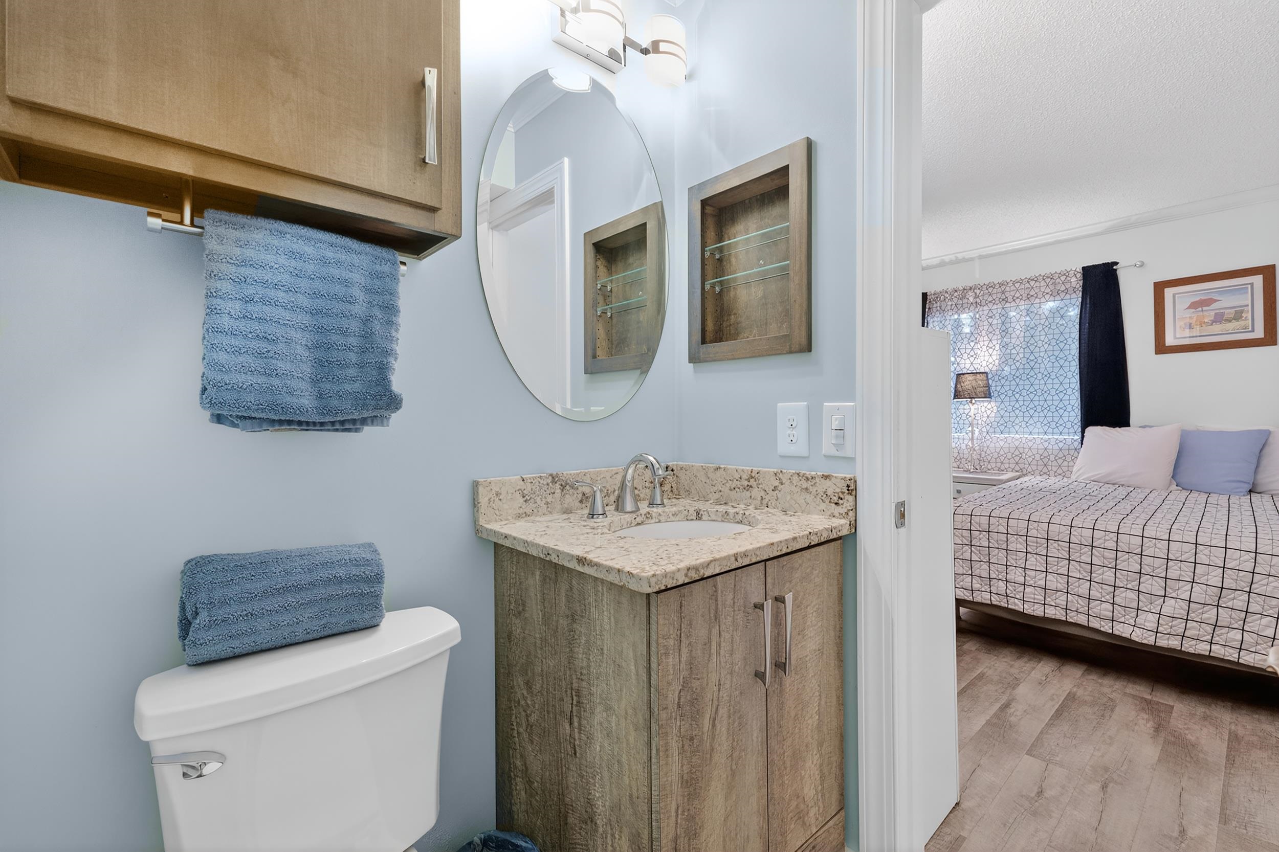 9581 Shore Drive, Unit 229 Myrtle Beach, SC 29572 - Photo 32 of 39 Bathroom featuring vanity, light wood-style flooring, and ensuite bathroom