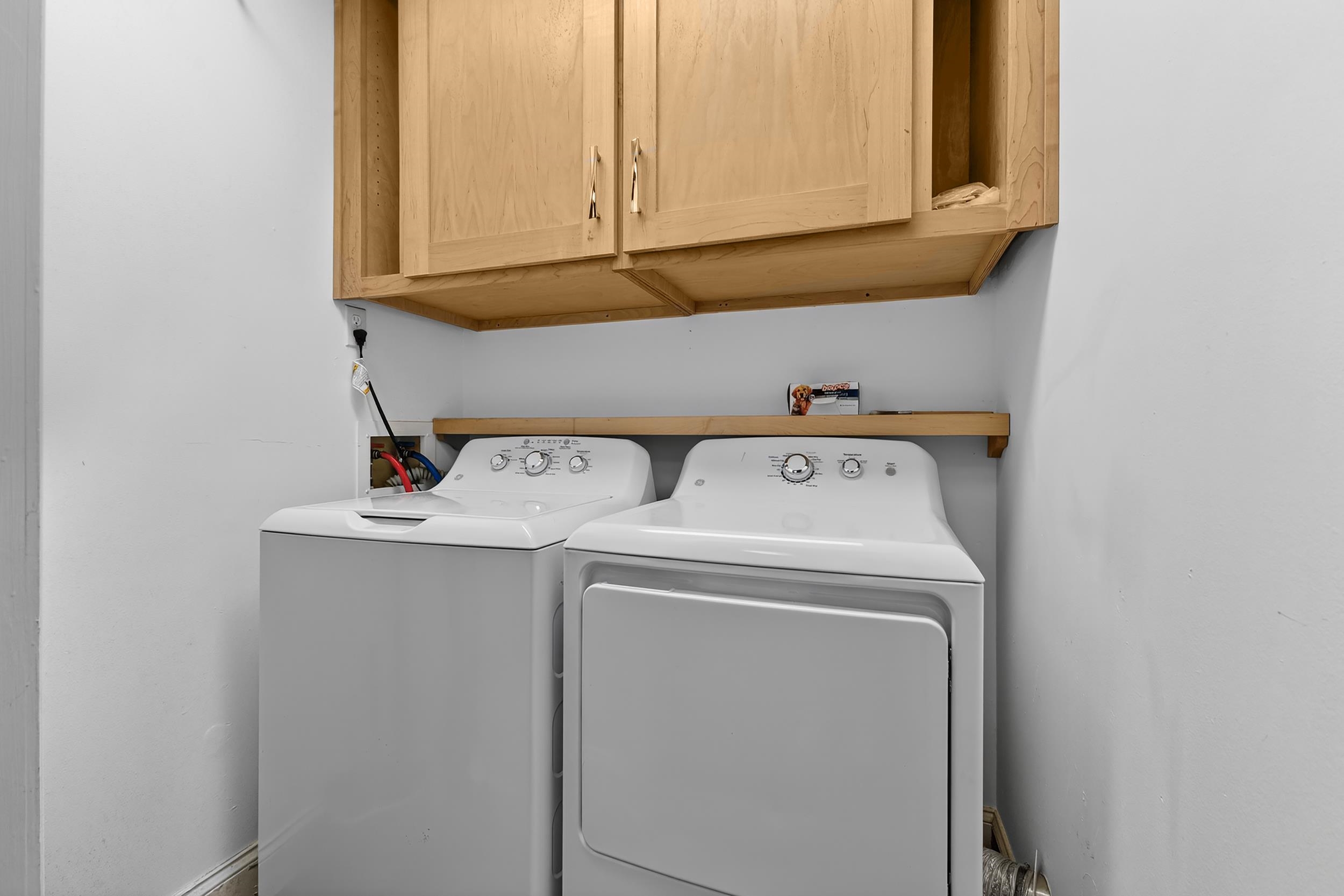 9581 Shore Drive, Unit 229 Myrtle Beach, SC 29572 - Photo 33 of 39 Laundry room featuring washing machine and dryer and cabinet space