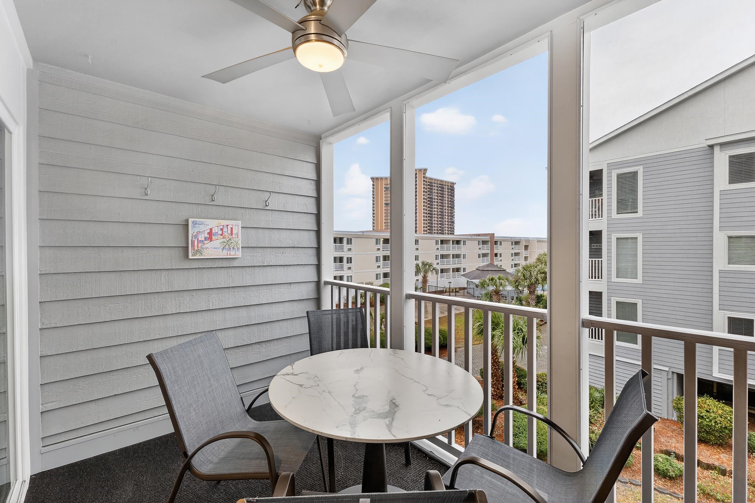 9581 Shore Drive, Unit 229 Myrtle Beach, SC 29572 - Photo 34 of 39 Balcony with ceiling fan and outdoor dining space