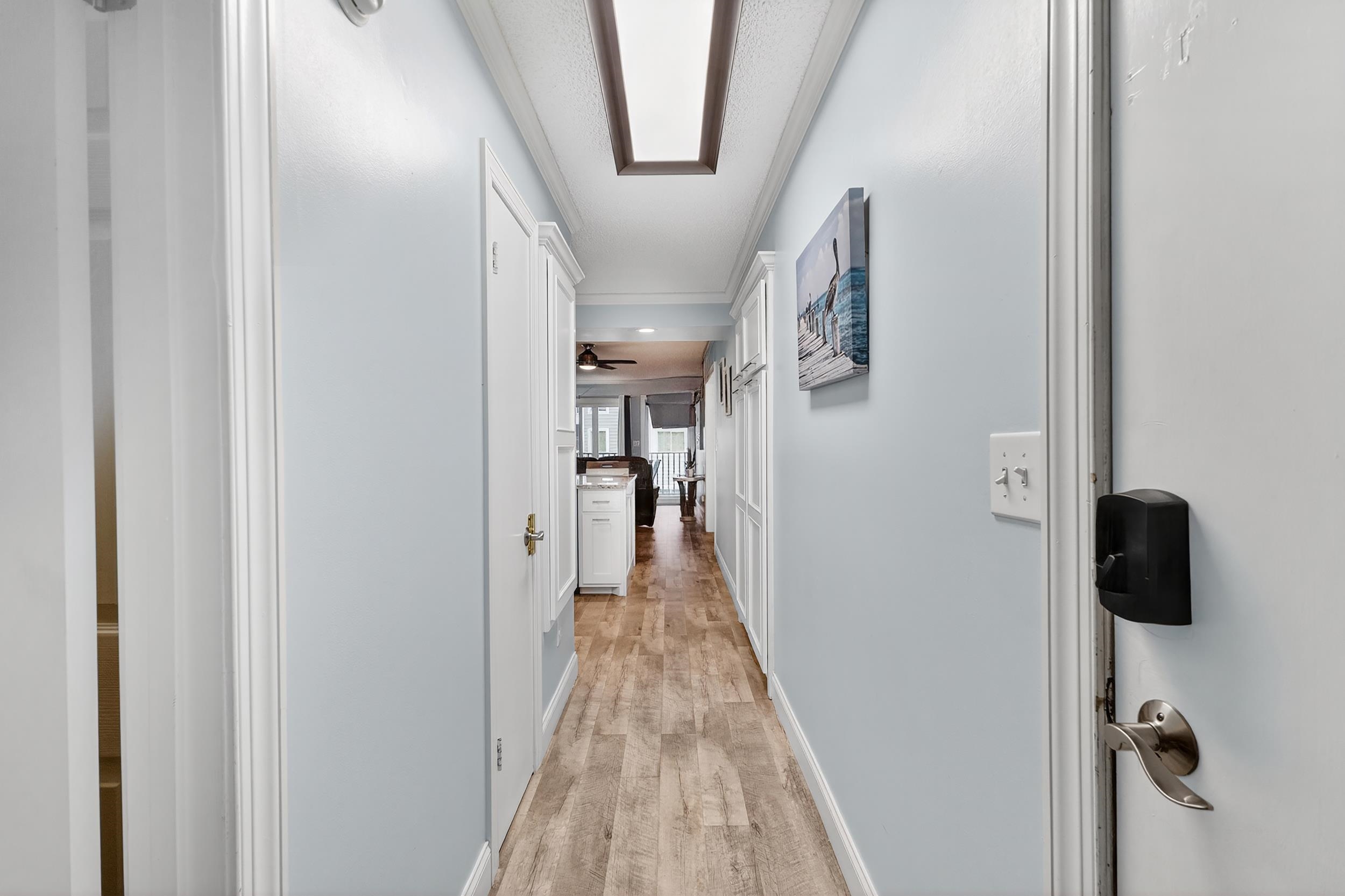 9581 Shore Drive, Unit 229 Myrtle Beach, SC 29572 - Photo 4 of 39 Corridor featuring light wood-type flooring and ornamental molding