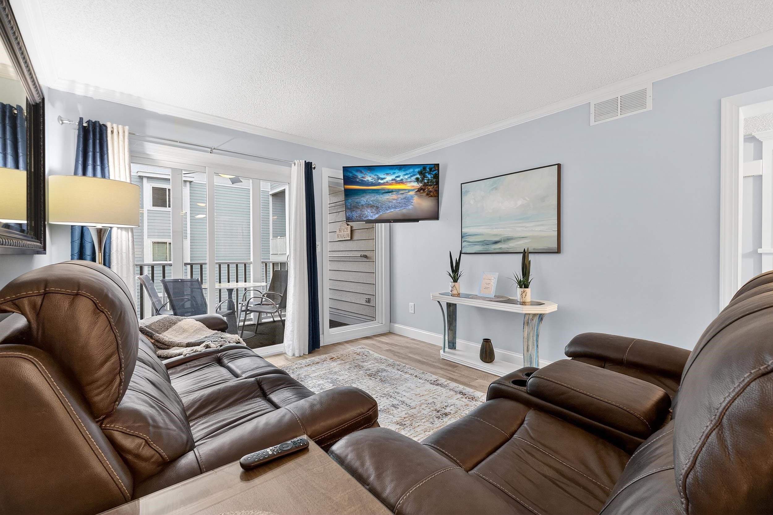 9581 Shore Drive, Unit 229 Myrtle Beach, SC 29572 - Photo 6 of 39 Living area with a textured ceiling, wood finished floors, and crown molding