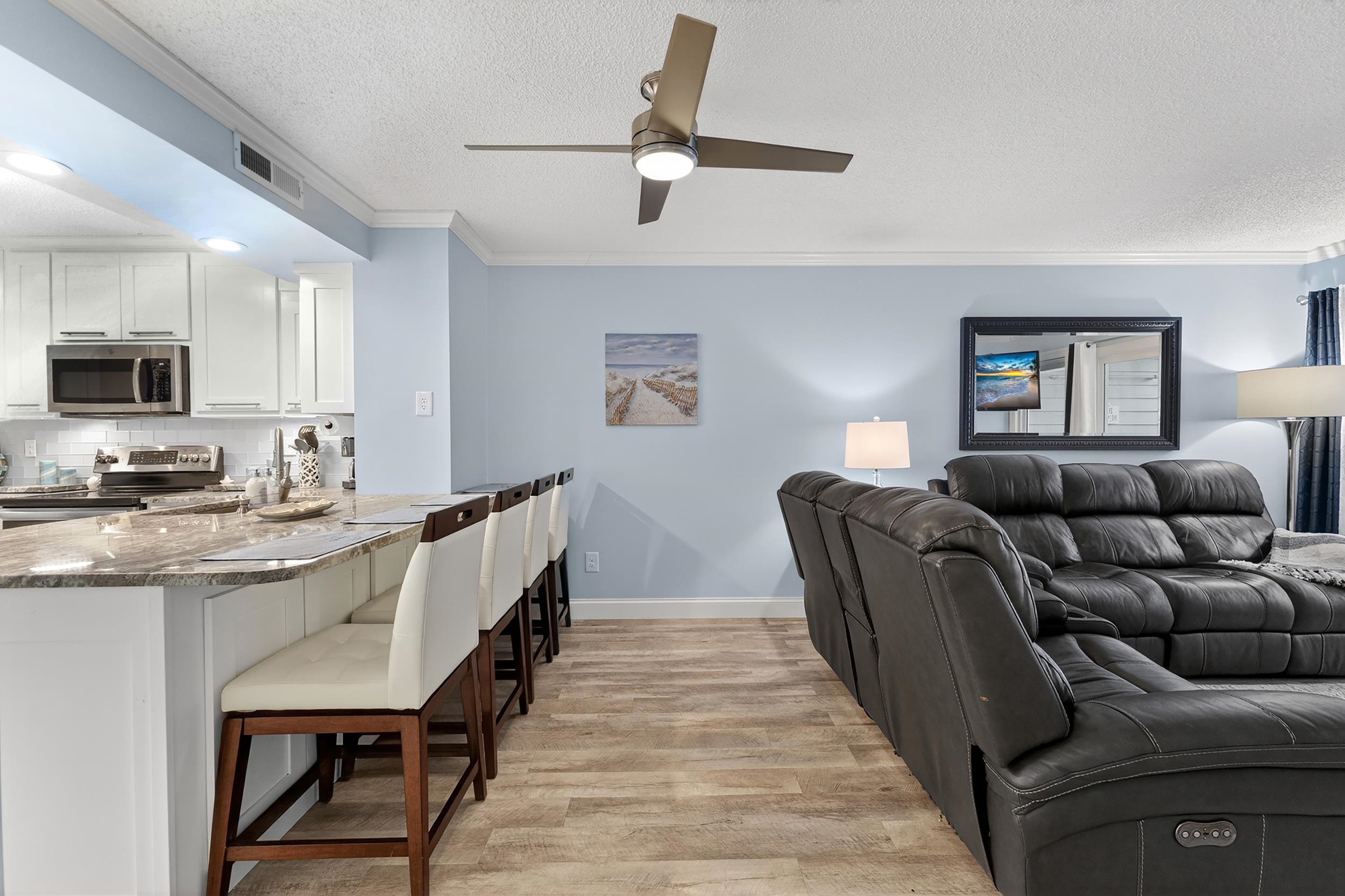 9581 Shore Drive, Unit 229 Myrtle Beach, SC 29572 - Photo 9 of 39 Living area with ornamental molding, light wood-style floors, a textured ceiling, and ceiling fan