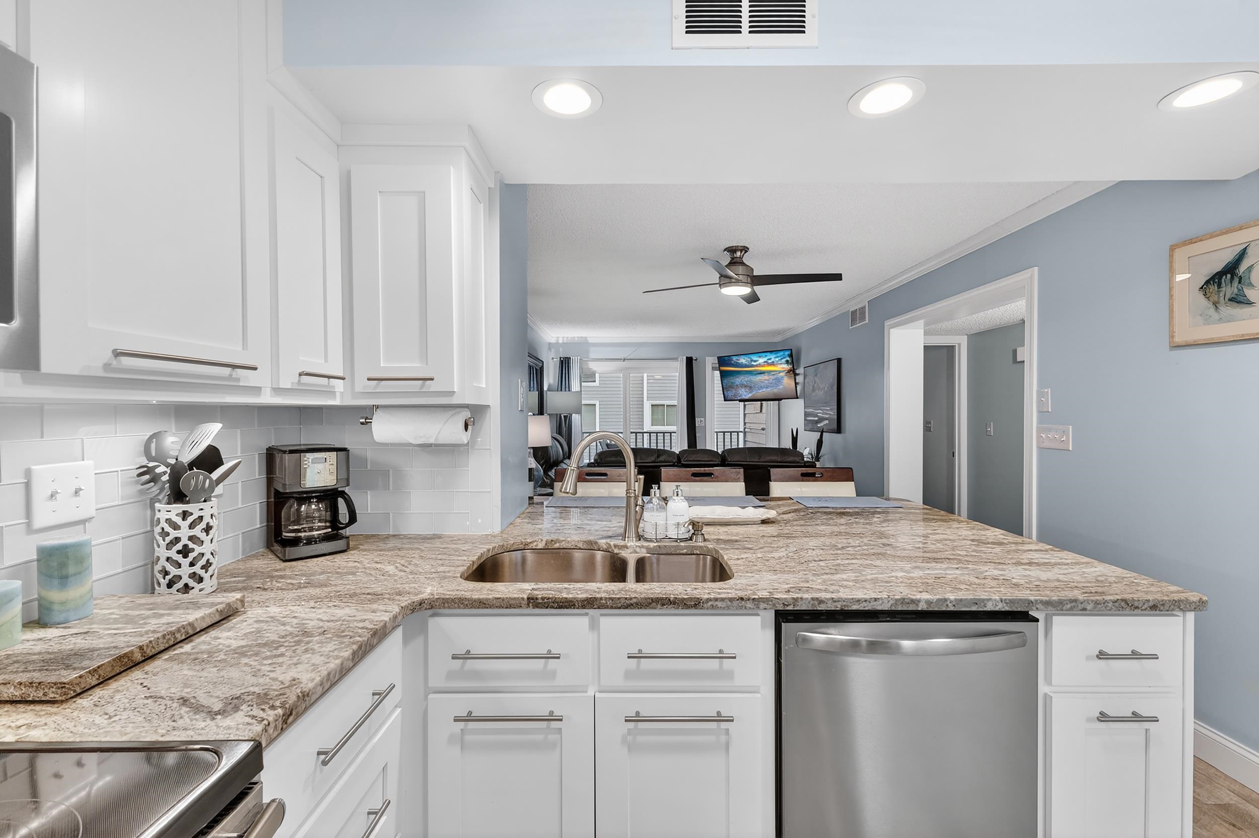 9581 Shore Drive, Unit 229 Myrtle Beach, SC 29572 - Photo 38 of 39 Kitchen with open floor plan, white cabinets, appliances with stainless steel finishes, a peninsula, and light stone countertops