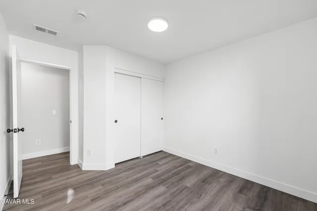 a view of a room with wooden floor