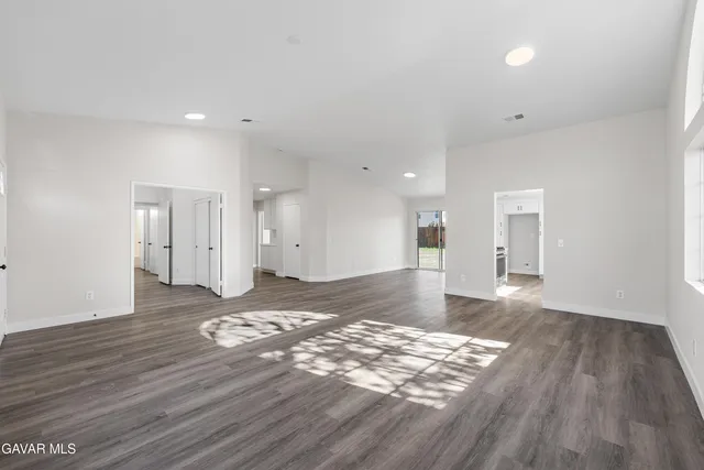 a view of a room with wooden floor and natural light