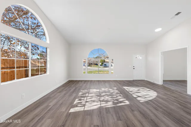 wooden floor in an empty room with a window