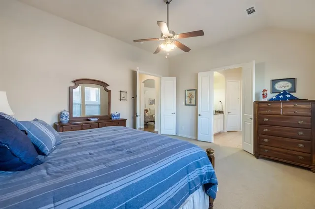 a bedroom with a bed and a dresser