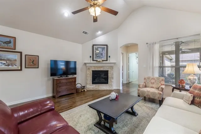 a living room with furniture a fireplace and a flat screen tv