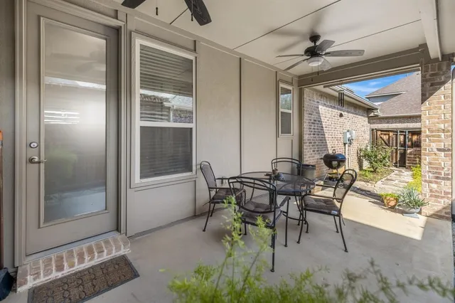 a view of a patio with table and chairs and potted plants