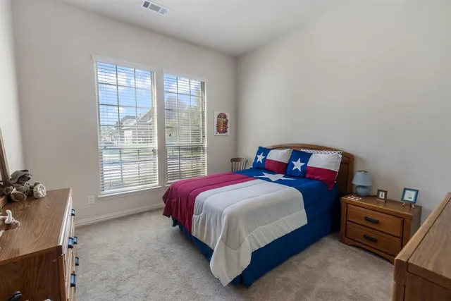 a bed sitting in a bedroom next to a window