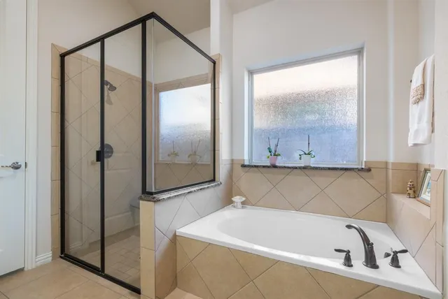 a bathroom with a tub and a shower