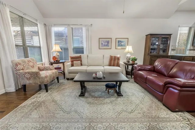 a living room with furniture lamp and window