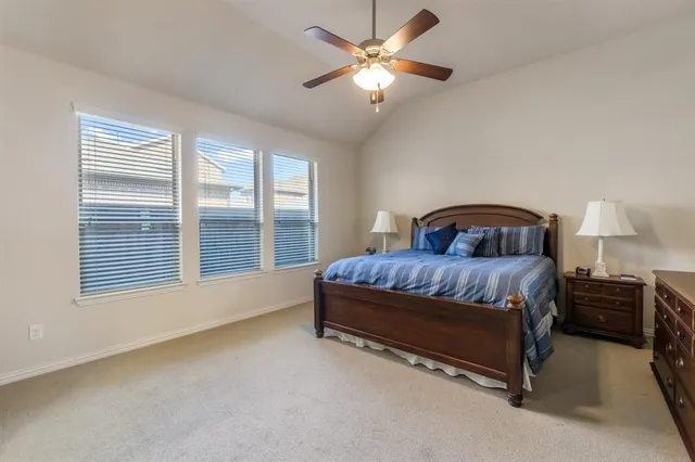 a bedroom with a bed dresser and window