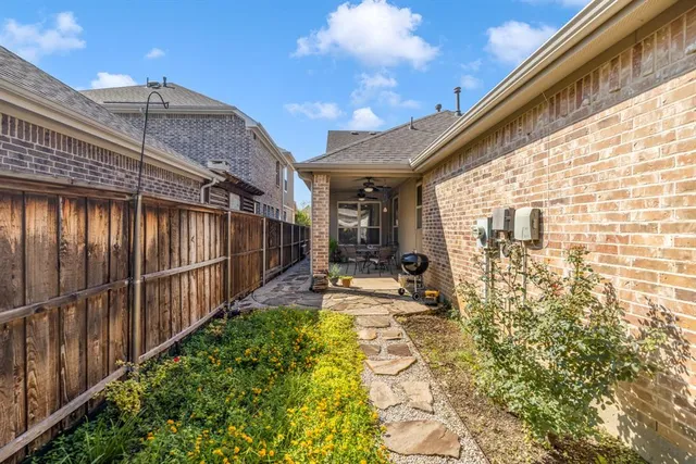 a kitchen with a stove sink cabinets and wooden floor