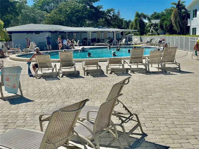 a view of a patio with dining table and chairs with wooden floor