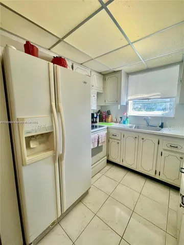 a kitchen with cabinets a sink and appliances