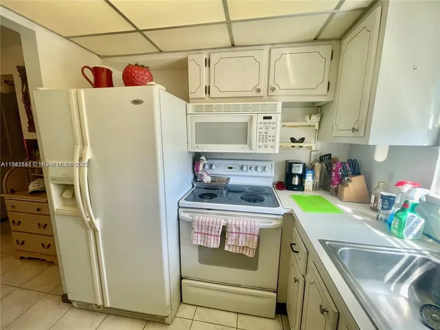 a kitchen with stainless steel appliances granite countertop a refrigerator and a stove