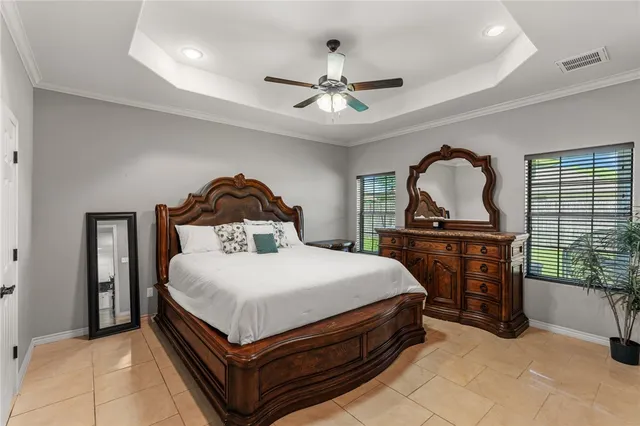 a bedroom with a bed and a dresser with mirror