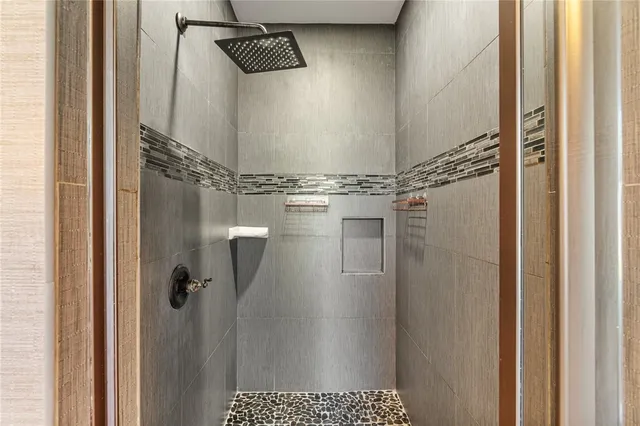 a bathroom with a glass shower door