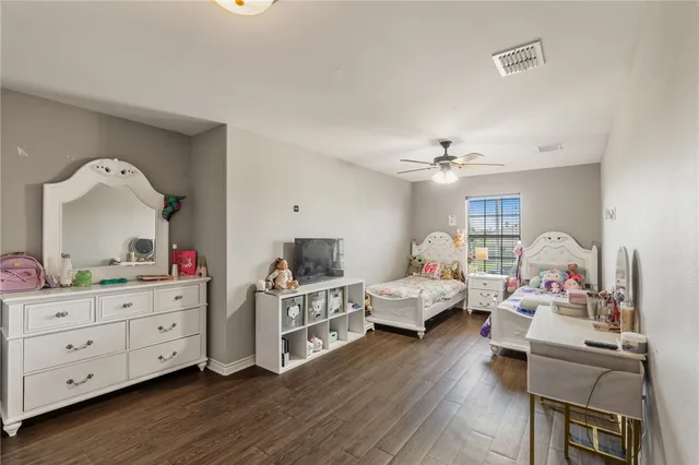 a bedroom with furniture and wooden floor